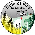 Cartoon photo of helicopter dropping water to protect a cabin from an approacing fire - button size